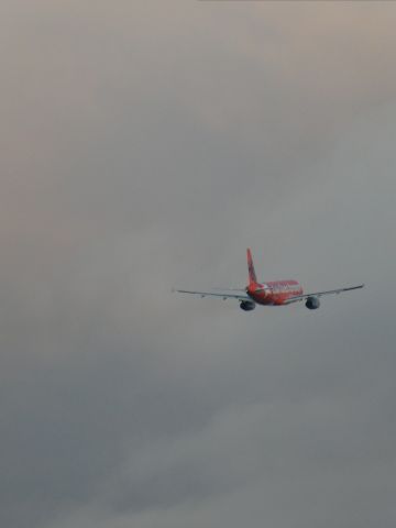 — — - Jetstar Orange departing into the grey cloud