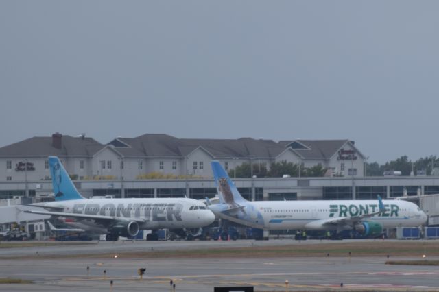 Airbus A319 (N927FR) - One of Providences newest airlines Frontier Airlines. The Frontier A319 taxis out to New Orelans while the A321 gets ready to push back for Orlando.