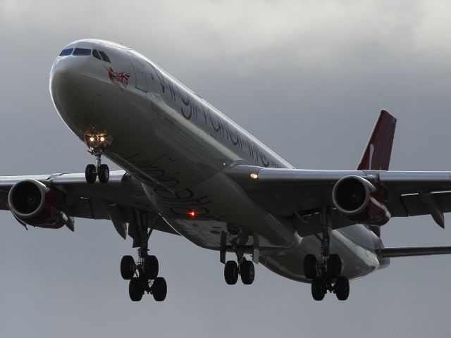 Airbus A340-300 (G-VFAR) - Interesting light greets the arrival of this Virgin Atlantic A340-300.