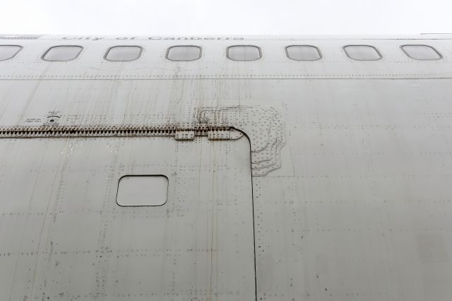 Boeing 747-400 (VH-OJA) - I am not certain if the reinforcement around the aft cargo door of this B744 was a result of ramp rash i.e. an impact from a vehicle or a structural enhancement.