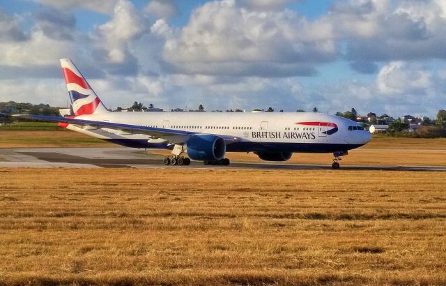 Boeing 777-200 (G-VIIY) - British Airways 777-200 as it is taking off from TBPB. Taken with an older phone, that being the reason for the noise in the picture.