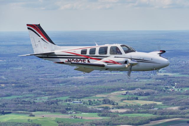 Beechcraft Baron (58) (N282EA) - Air to Air image taken from the open window of a Cessna 172.  That is why the Baron has his flaps down.  