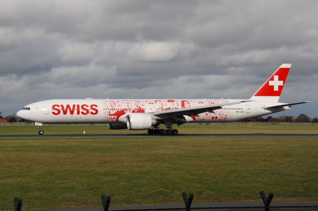 BOEING 777-300ER (HB-JNA) - arriving to have its "Faces of Swiss" decals removed. Dublin Airport 22nd February 2017.