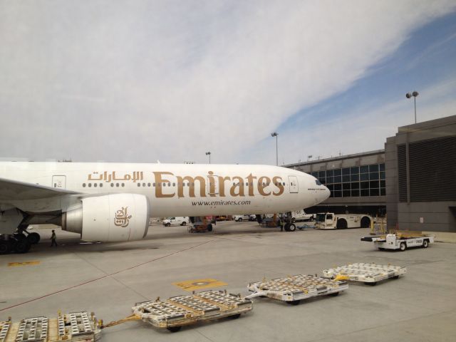 Boeing 777-200 (A6-EGC) - i was taking the mobile lounge to the international arrivals terminal and saw this Emirates 777-300ER while driving by.