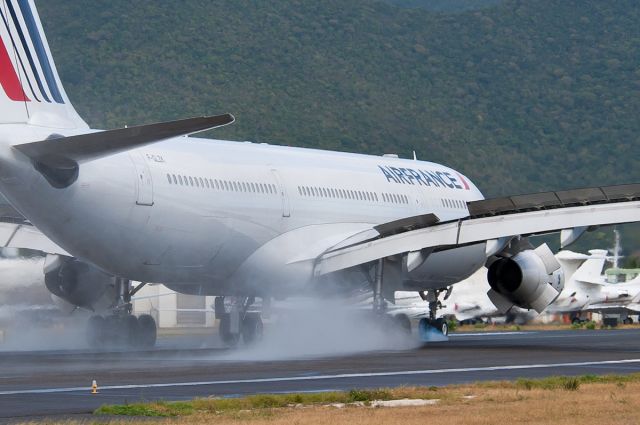 Airbus A340-300 (F-GLZK) - Nose wheel just contacted on the wet runway...