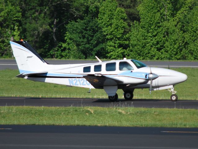 Beechcraft Baron (58) (N212CH) - CIRRUS HOLDINGS LLC taxiing to runway 2 at KJQF - 5/26/13