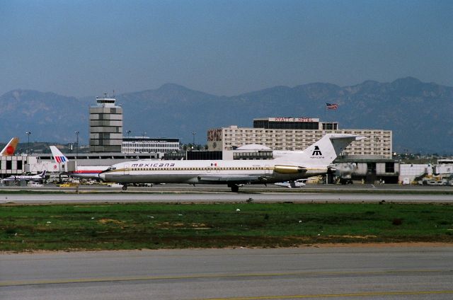 BOEING 727-200 (N129NA) - KLAX - Mexicana 727 arriving from MEX on Runway 25L - waiting to cross 25R.