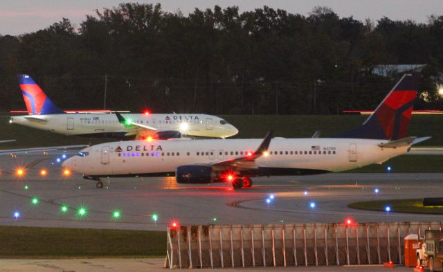 Boeing 737-800 (N3759) - Delta 737-800 and a Delta A220-100 awaiting departure on a early morning.