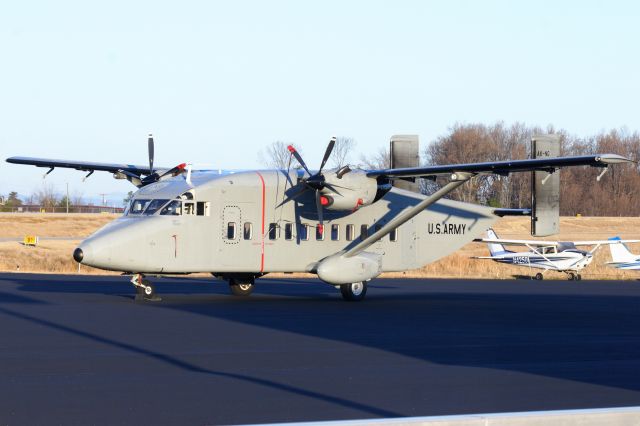 — — - US Army C-23B parked on the GA ramp at KGMU.