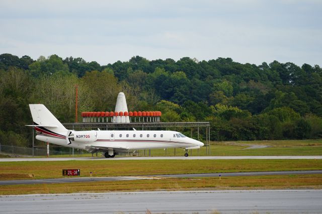 Cessna Citation Sovereign (N397QS) - PDK has an elevated platform that gives you a clear view of the runway.  Next to the platform is a picnic area and swings for children.  I like to capture landing planes as they pass the VOR, because at that point their reverse thrusters are usually open