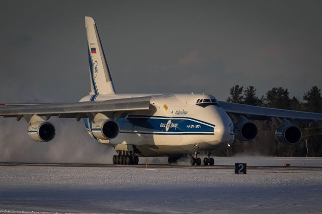 Antonov An-124 Ruslan (RA-82045) - Volga Dnepr puffing smoke from the tires and snow from the runway as it touches down on 15 in Bangor.