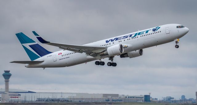 BOEING 767-300 (C-FOGJ) - WestJets new 767 lifts off runway 23 and heads to Calgary