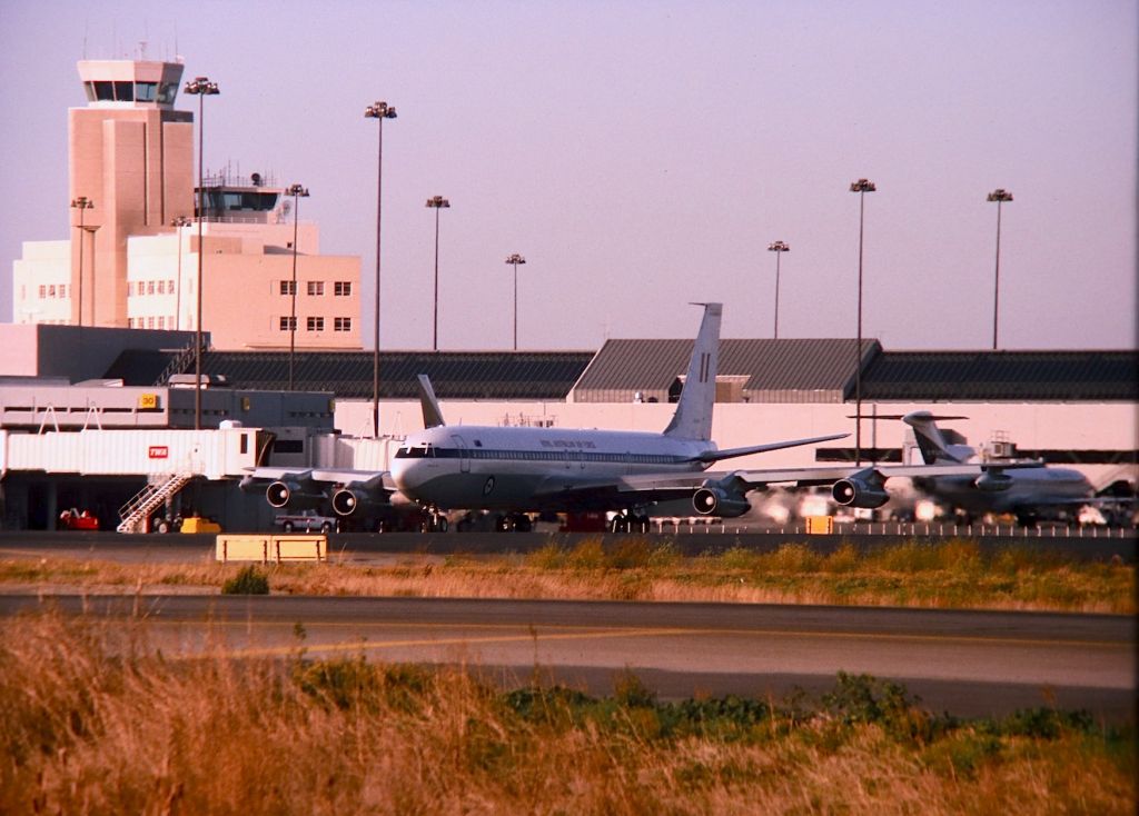 Boeing 707-300 (A20324) - KSFO - RAAF Boeing 707-338 on taxi towards the Runway 1R hold bars. A20-324 had what looked like air to air refueling pods on each wingtip - this jet was parked at the International dock and had pushed back shortly after I arrived on this late PM day - date apprx Fall 1993. Color slide converted to digital.