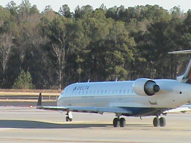 Canadair Regional Jet CRJ-700 (N724EV) - A Delta Connection CRJ-701ER Charter Flight with a Sports Team on the plane which is taxiing down the road to take of 23L at RDU.