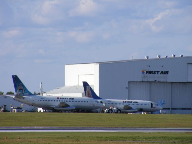 Boeing 737-200 (C-GSPW) - being towed to its hangar while another 737 is being prepped.