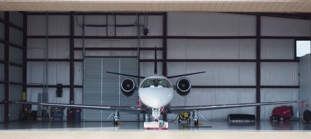 Cessna Citation Excel/XLS (N322JC) - Beautiful aircraft on a beautiful evening, Tyler, Texas, July 2022. Notice the engine cowling sitting on the hanger floor from the (as you look at this picture) right engine. Best viewed in full.