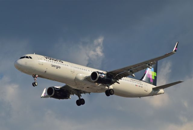 Airbus A321 (XA-VLT) - Airbus A321-321 XA-VLT MSN 7125 of Volaris named "Sergio" on approach at Mexico City International Airport (07/2018).