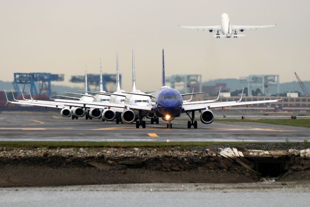 Airbus A320 (N531JL) - As Scandinavian 928' lifts off for Copenhagen, 'Blue Bravest' leads a line of backed-up departures holding on taxiway 'Mike' after an hour plus ground stop due to severe thunderstorms and wind as well as a microburst.