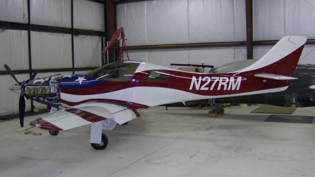 Lancair Legacy 2000 (N27RM) - This Lancair Legacy has a stars&stripes paint job.   The cowling was removed in the Redmond (KRDM) hangar for work on the IO-550 engine.  The paint job is very similar to TWO other Lancairs N550AC and N948JT.