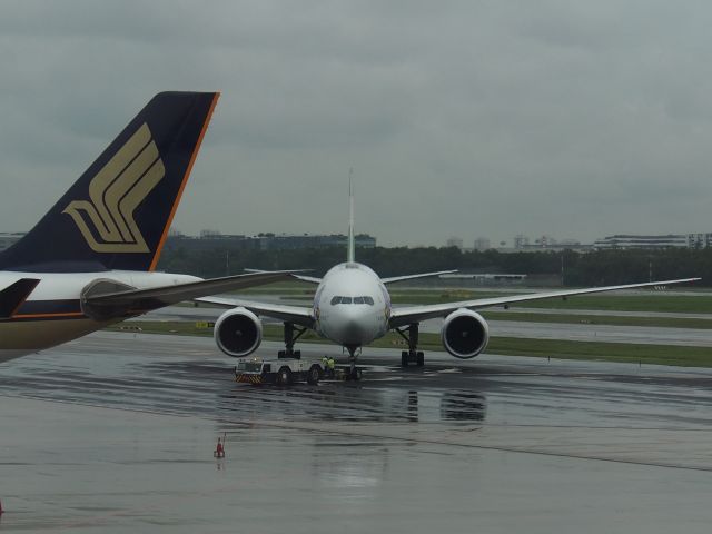 BOEING 777-300 (B-16722) - EVA 777 on pushback from gate @ Changi taken from departures.