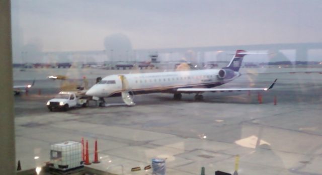 Canadair Regional Jet CRJ-200 (KCVG) - My buddy was on this flight from CVG to CLT - if you look closely they are replacing the windsheild.. They brought another plane in from CLT -and this one took off empty back to CLT.