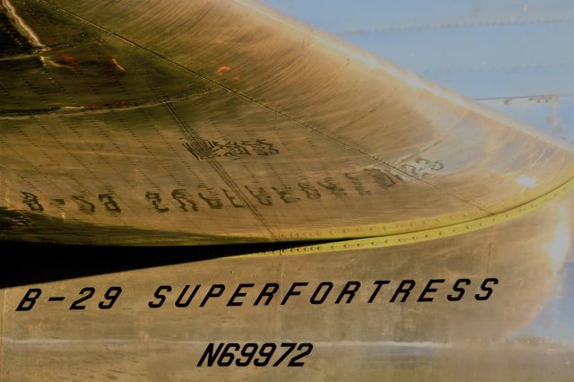 Boeing B-29 Superfortress (N69972) - Docs Shiny Aluminum below the Tail Structure as the Sun Sets on it.  