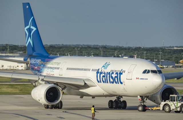 Airbus A330-200 (C-GTSR) - Air Transat charter being towed to parking at gate B7 after arrival.br /6/15/17