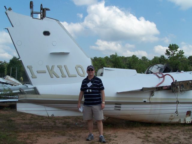 Learjet 55 (I-KILO) - I-KILO Learjet 55 seen here after a mishap in Spain in 94 my traveling partner was Roy T seen here making notes and smiling after seing all the aircraft here, a truly awesome place and really nice people as well.. ...Photo by Mike Day