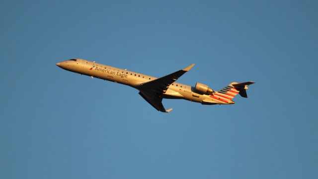 Canadair Regional Jet CRJ-900 (N955LR) - An evening departure from DFW as seen from Founder's Plaza.