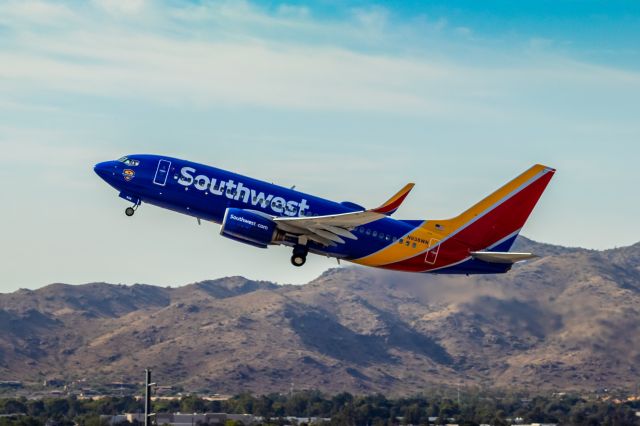 Boeing 737-700 (N938WN) - Southwest Airlines 737-700 taking off from PHX on 9/28/22. Taken with a Canon 850D and Rokinon 135mm f/2 manual focus lens.