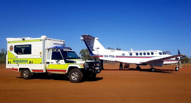 Beechcraft Super King Air 200 (VH-FDA) - Working aircraft. Royal Flying Doctor Service loading a patient at Burke & Wills Roadhouse for Medivac to hospital.