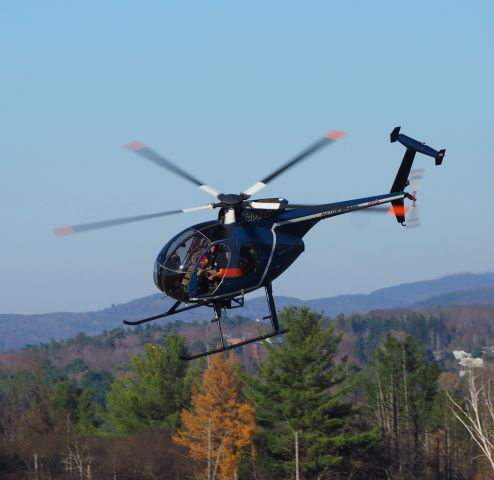 MD Helicopters MD 500 (N405AT) - Taking off after refueling during a nice Sunday visit . These copters are outfitted to carry sawblades to do tree cutting along powerline rights of way .