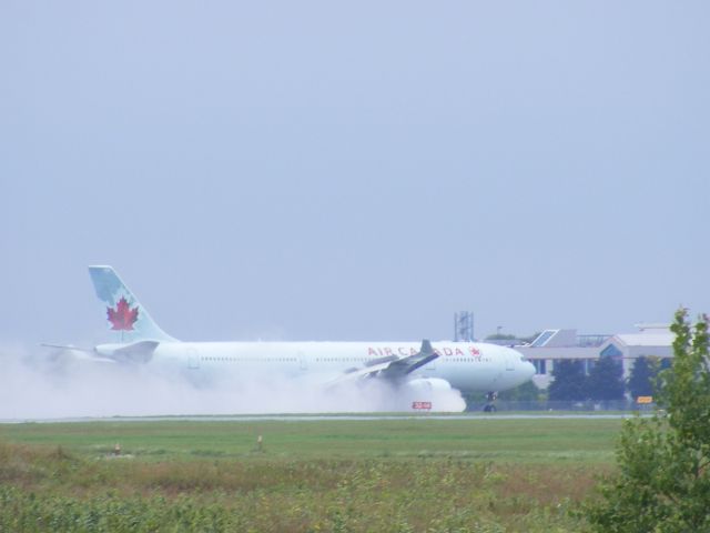 Airbus A330-300 — - throwing engines into reverse for braking on a wet runway