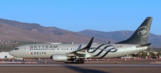 Boeing 737-800 (N3758Y) - Delta's N3758Y, dressed in the "Skyteam" alliance livery, accelerates past me as it makes its first-revenue-flight-of-a-new-day departure (6:25 AM) down RNO's 16L.br /br /Just some added information ...br /The Skyteam airline alliance consists of 19 members ..br /br /In no particular order: Delta, Air France, KLM, Aeroflot, Alitalia, Aeromexico, Korean Air, China Airlines, China Eastern, Aerolíneas Argentinas, AirEuropa, Czech Airlines, Garuda, MEA, Kenya Airways, Saudi, Vietnam Airlines, Tarom, and Xiamen Air.