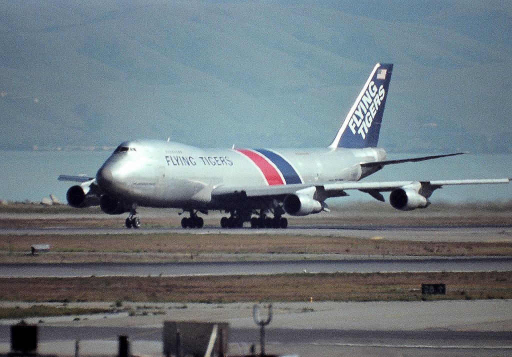 Boeing 747-200 (N815FT) - KSFO - "Henry Renninger" departing 28R at San Francisco - taken from atop the parking garage with a 1000mm Celestron C-90 lens, Minolta XD-11 - color slide film and a bit grainy - but one of only a few Flying Tiger 747 shots I got over the years.br /br /22150br /Line Number 476br /Aircraft Type Boeing 747-245F(SCD)br /First Flight 22. Sep 1980br /Age 32.7 Yearsbr /Production Site  Paine Field (PAE)br /Airframe Status Scrapped