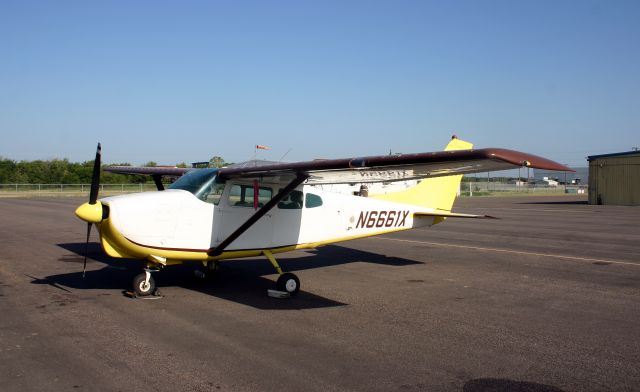 Cessna Centurion (N6661X) - This Centurion is parked outside of Ed Tilmans hangar as a 72-year old Piper Cub receives some tender loving care.