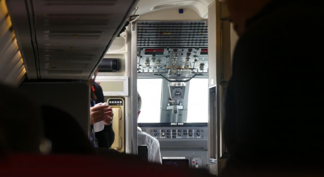 Embraer ERJ-145 (N664MS) - Cockpit view from aisle seat.