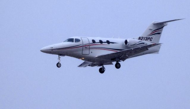 Beechcraft Premier 1 (N213PC) - On final is this 2011 Hawker Beechcraft 390 Premier 1 through light snow in the Winter of 2019.