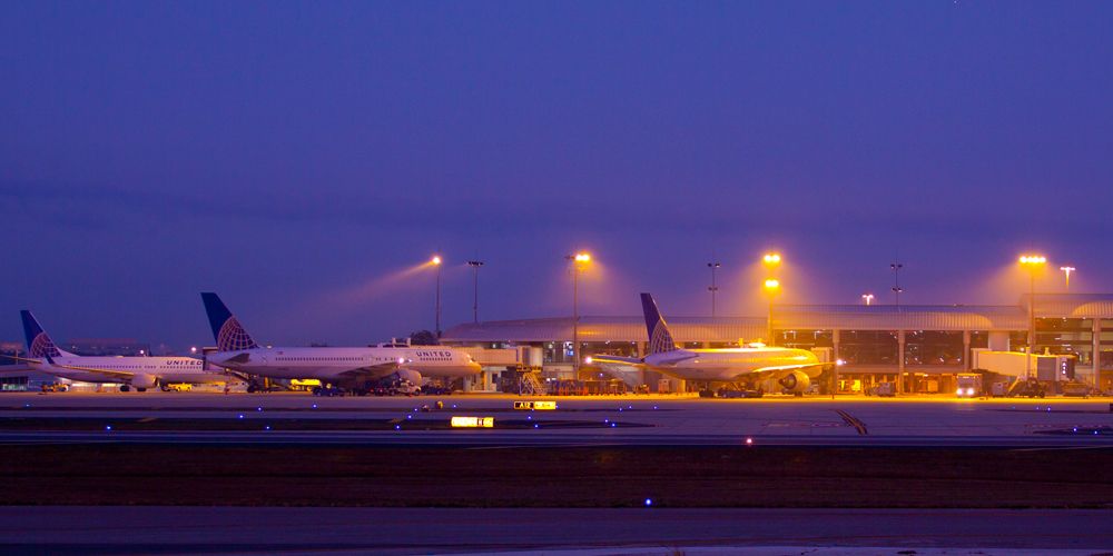— — - Foggy Morning at Tampa International looking across the tarmac to the United Airlines Terminals