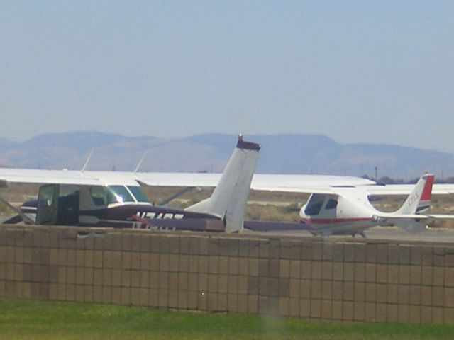 Cessna 152 (N74GT) - Parked in font of a light sport.