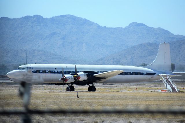 Douglas DC-7 (N777EA) - Seen stored near the end of the runway