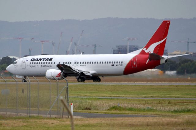 BOEING 737-400 (VH-TJE) - On taxi-way heading for Terminal 1 after landing on runway 23. Friday 5th October 2012.