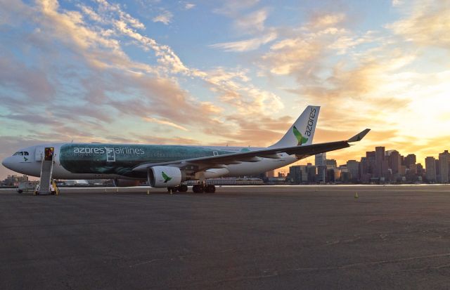 Airbus A330-200 (CS-TRY) - Boston Skyline view and rare parking on the RWY 14/32 overrun