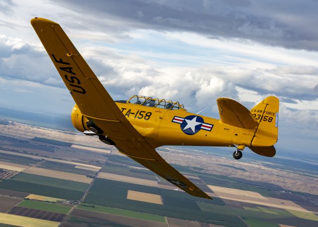 North American T-6 Texan (N158JZ) - "Miss Humboldt Hunny" over the Sacramento area. Photo credit and thanks to Mike Mainiero for the shot and Nick Coutches and Loren Marburg for getting this wonderful warbird into position. Additional thanks to the rest of the awesome people that worked on the photoshoot as well. Truly brought to life through the lens!