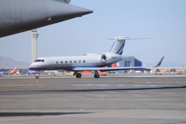 Gulfstream Aerospace Gulfstream V (N337LS) - Taxing for departure Runway 36. KSLC tower in the background, and under a C5 Super Galaxy. br /Best viewed in full! 