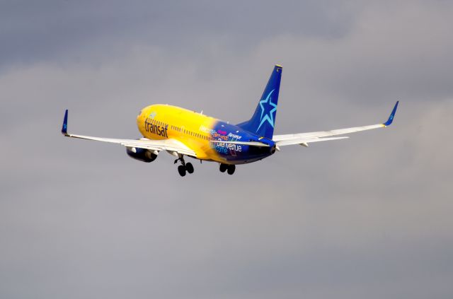 Boeing 737-700 (C-GTQP) - Air Transat 737-700 C-GTQP yellow take off in bad weather.