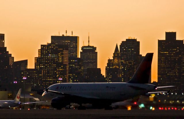 Airbus A319 (N339NB) - Winter sunsets @ KBOS Logan and Delta A319 N339NB getting ready for a 33L launch