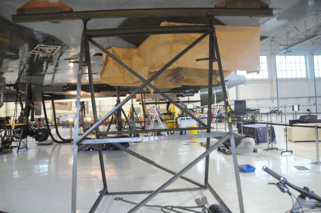 — — - Frame put under the wing of Vulcan XH 558 to place the wing under 1G of stress whilst the aircraft is having the undercarriage checked. the jacks can be seen in the background.