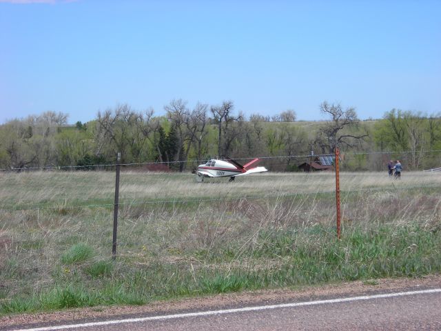 Beechcraft 35 Bonanza (N8SM) - damaged plane in field ... you can see that the left wing is missing