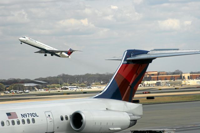 — — - Delta MD-90 Jet Takes-Off and MD-90 Company jet in Foreground Atlanta